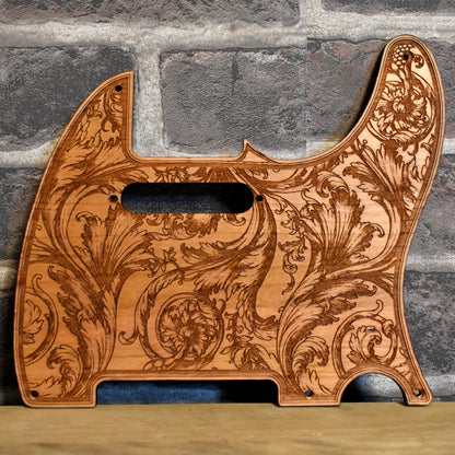 Floral wood pickguard for Telecaster electric guitar, laser-engraved design.