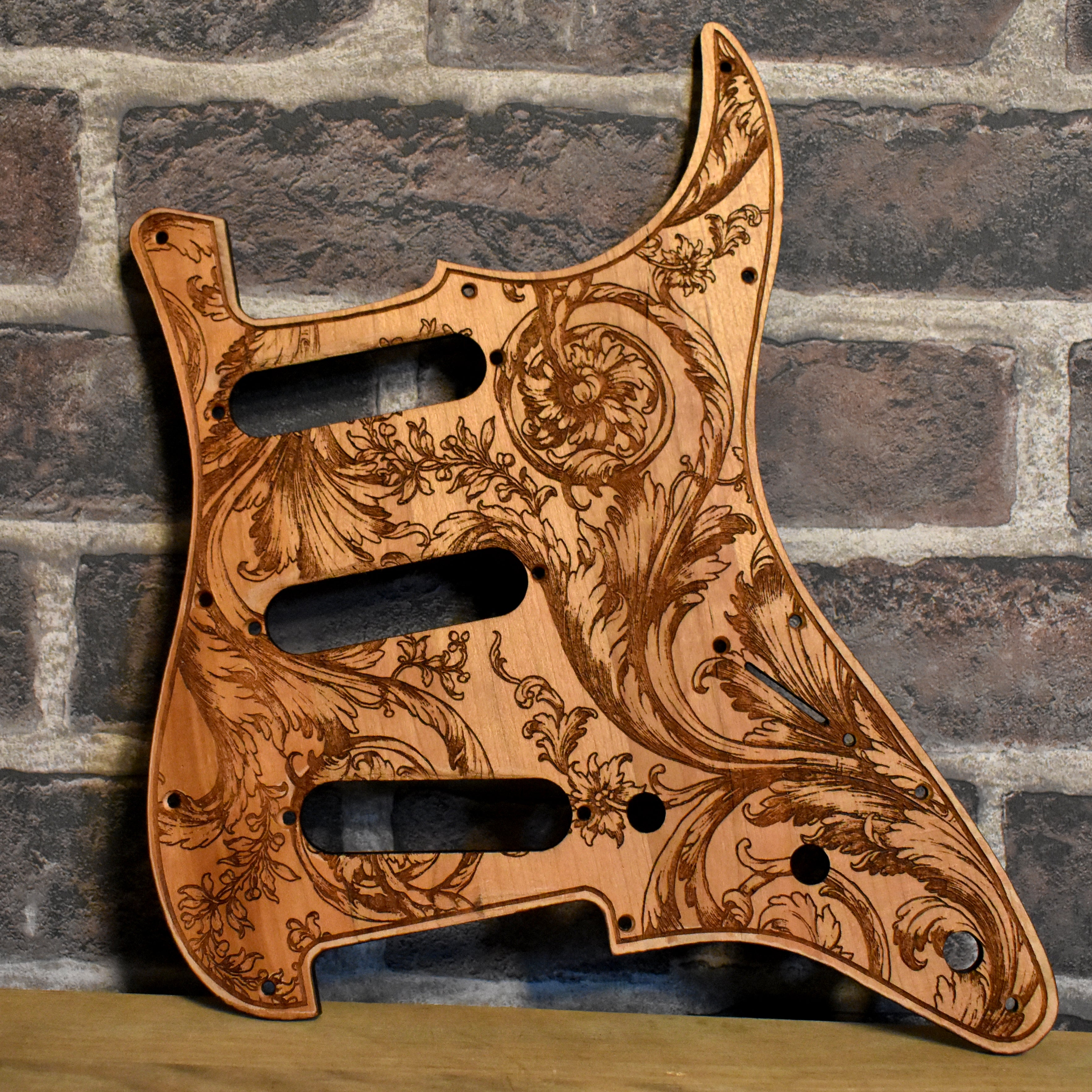 Floral wood pickguard for Stratocaster HSS and SSS electric guitars, laser-engraved design.