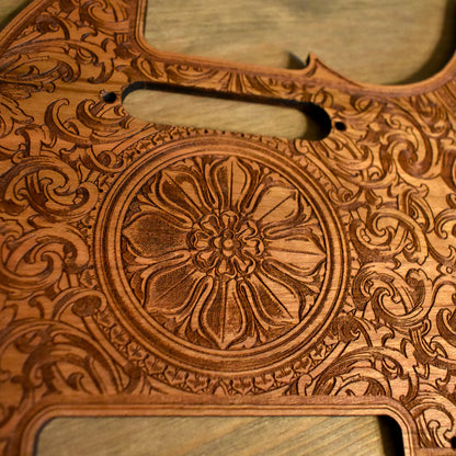 Unique laser-engraved wooden pickguard for Telecaster guitars, floral-inspired design.