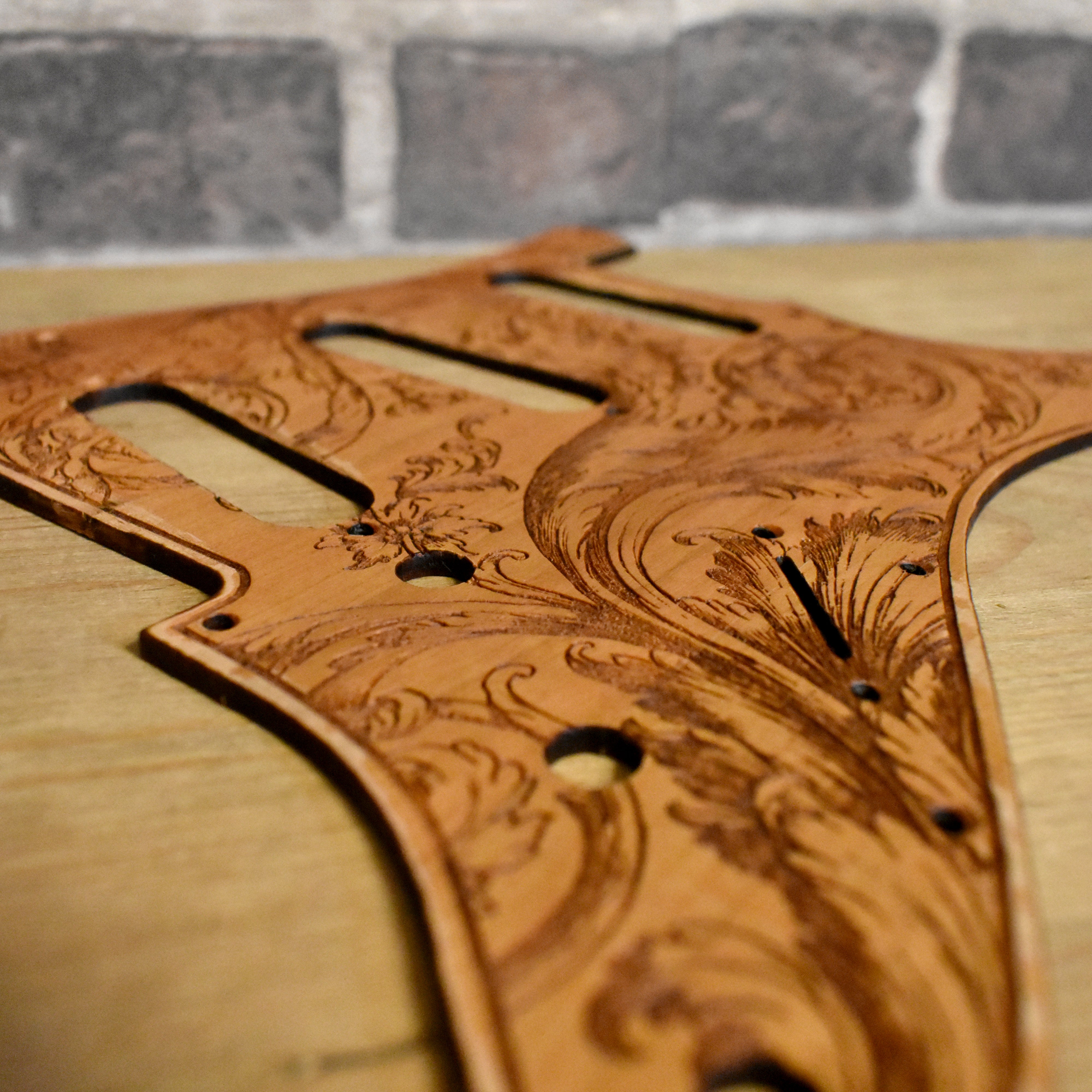 Custom Stratocaster pickguard featuring intricate floral wood engraving, HSS and SSS fit.