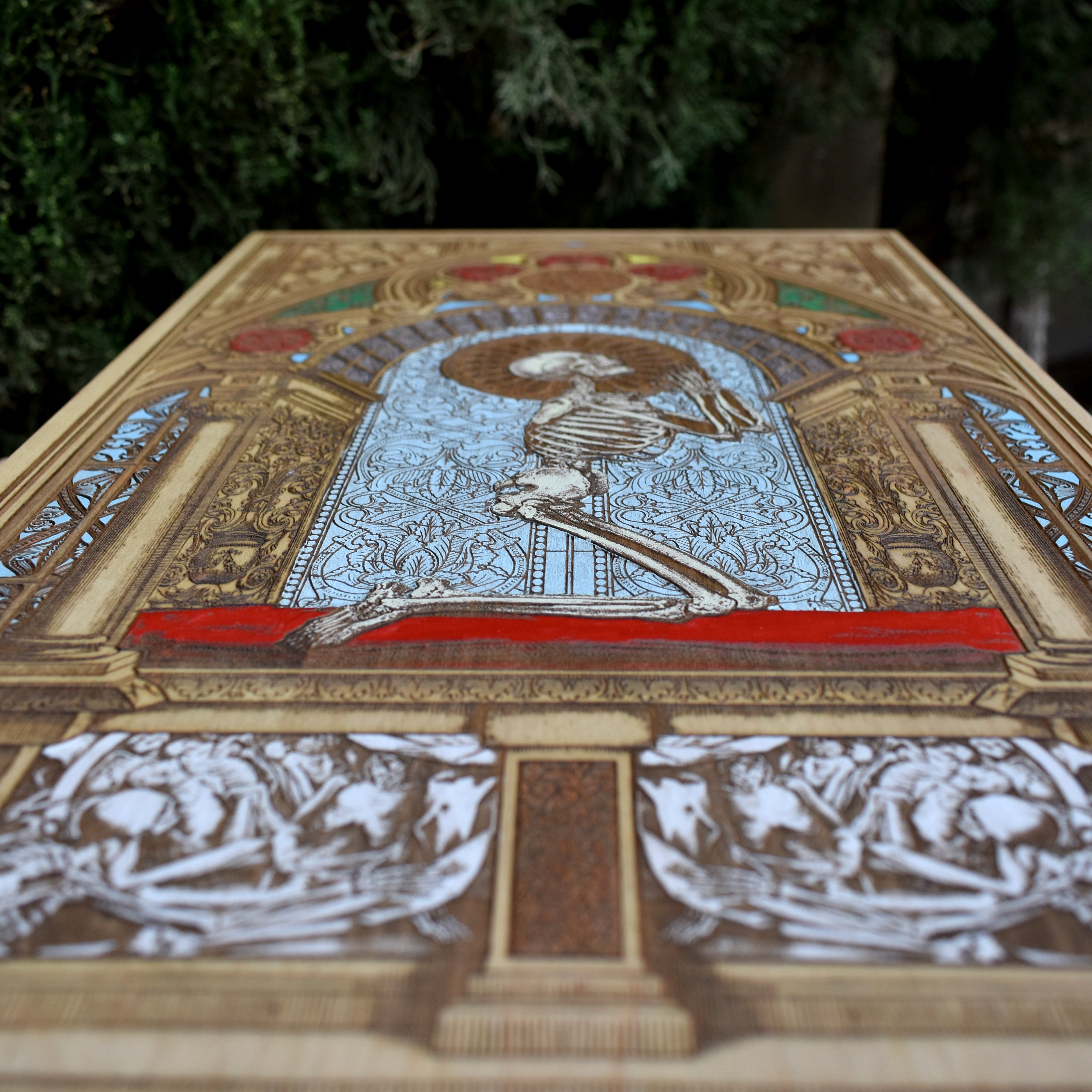 Wooden wall art featuring a hand-painted human skeleton in a prayer pose, with Memento Mori symbolism. Made from solid maple wood, customizable with a name, date, or special message. A meaningful gift.