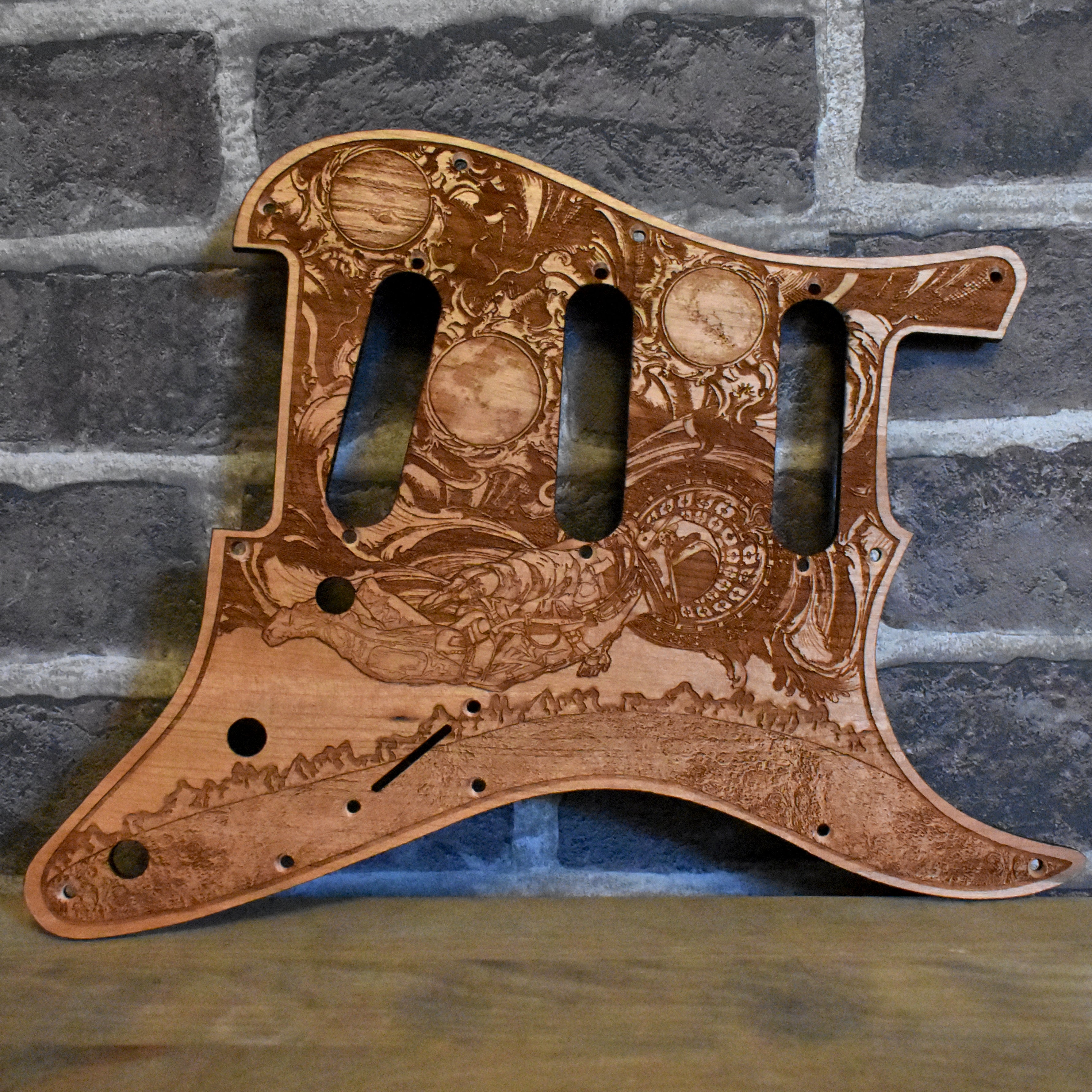 Cherry wood pickguard for Fender Strat, laser-engraved with intricate patterns.