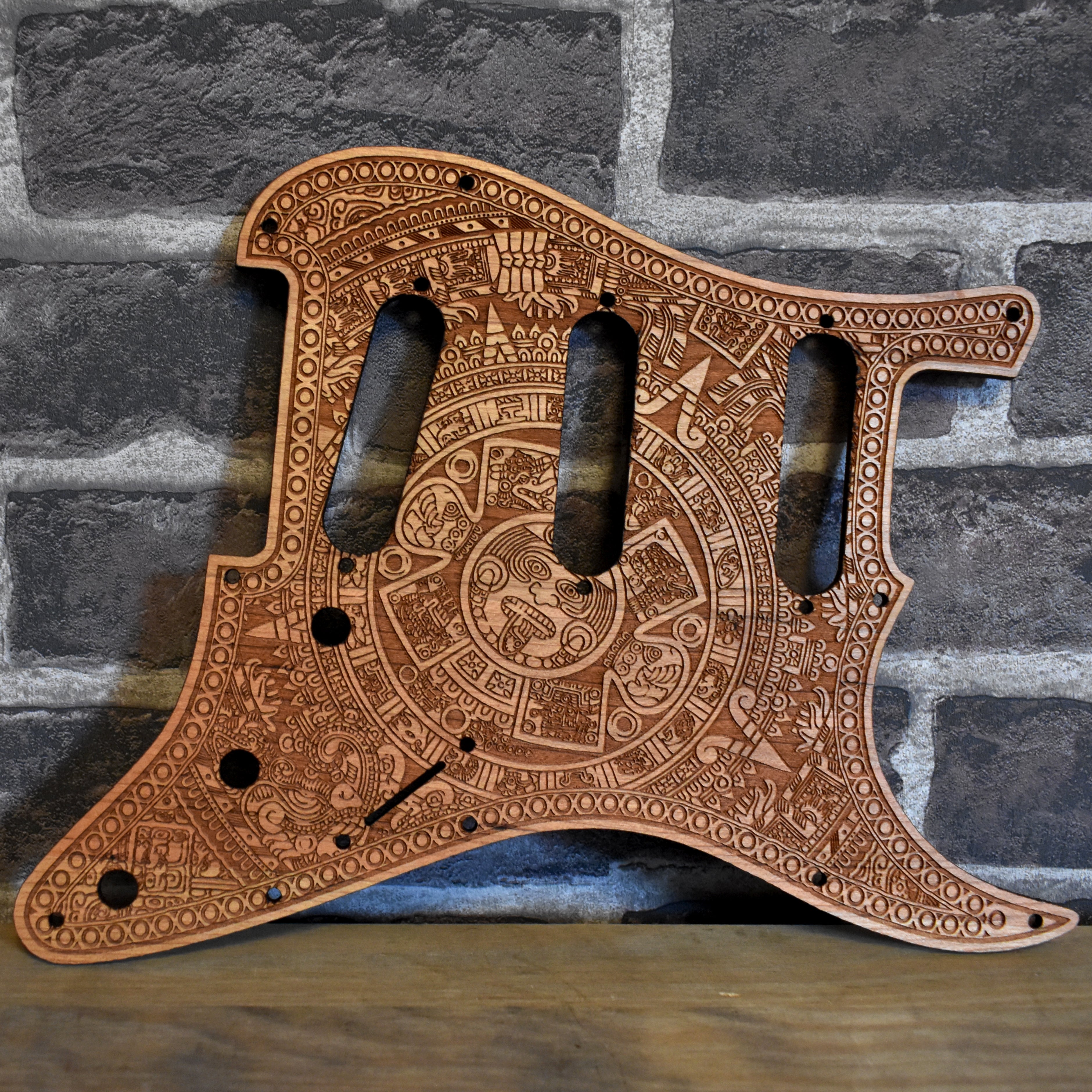 Cherry wood Fender Stratocaster pickguard with laser-engraved gothic artwork for HSS & SSS guitars.