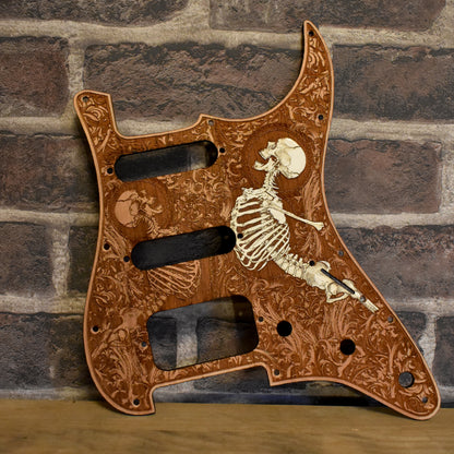 Cherry wood pickguard with laser-engraved artwork, custom fit for Fender Stratocaster HSS & SSS models.