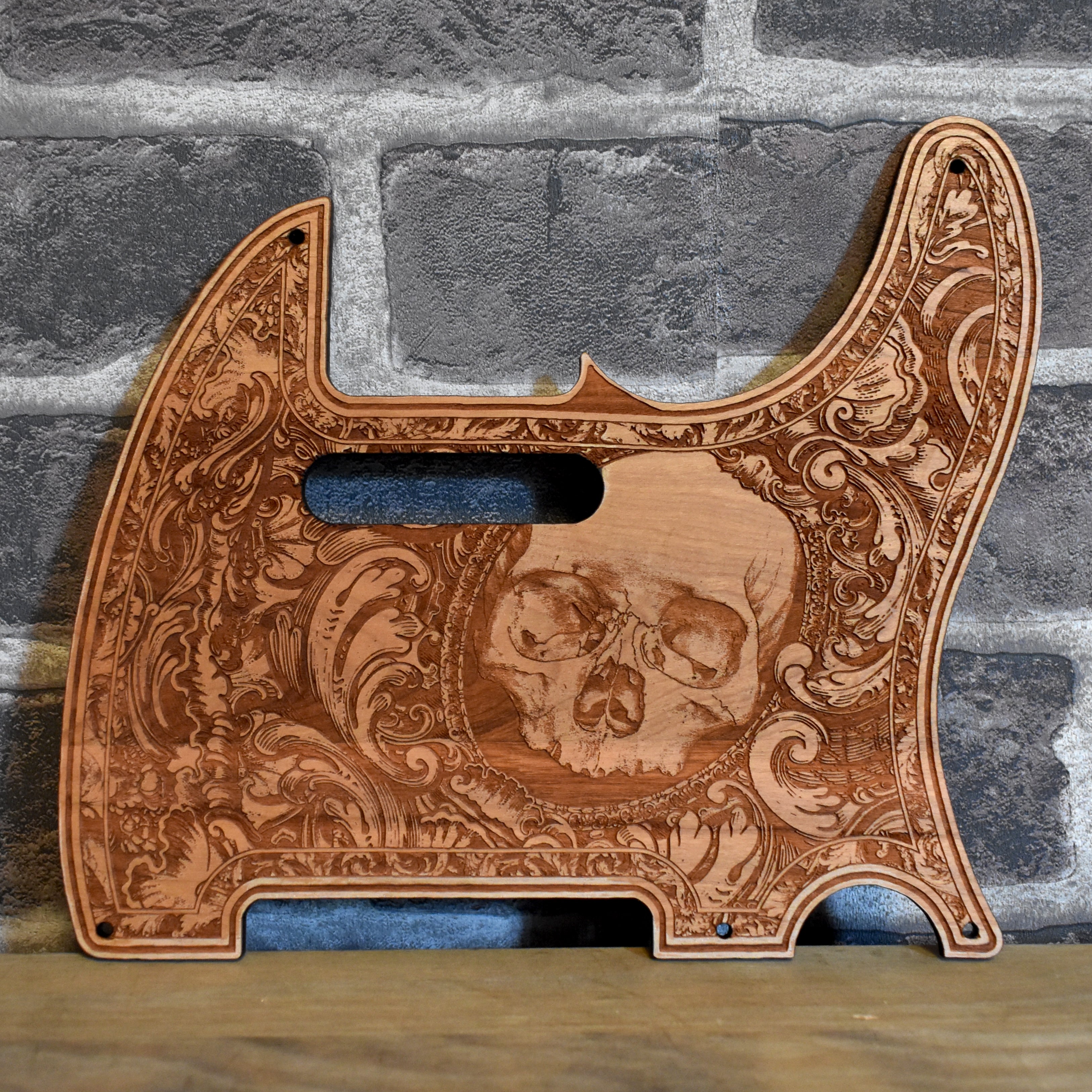 Fender Telecaster cherry wood pickguard with intricate laser-engraved skull design