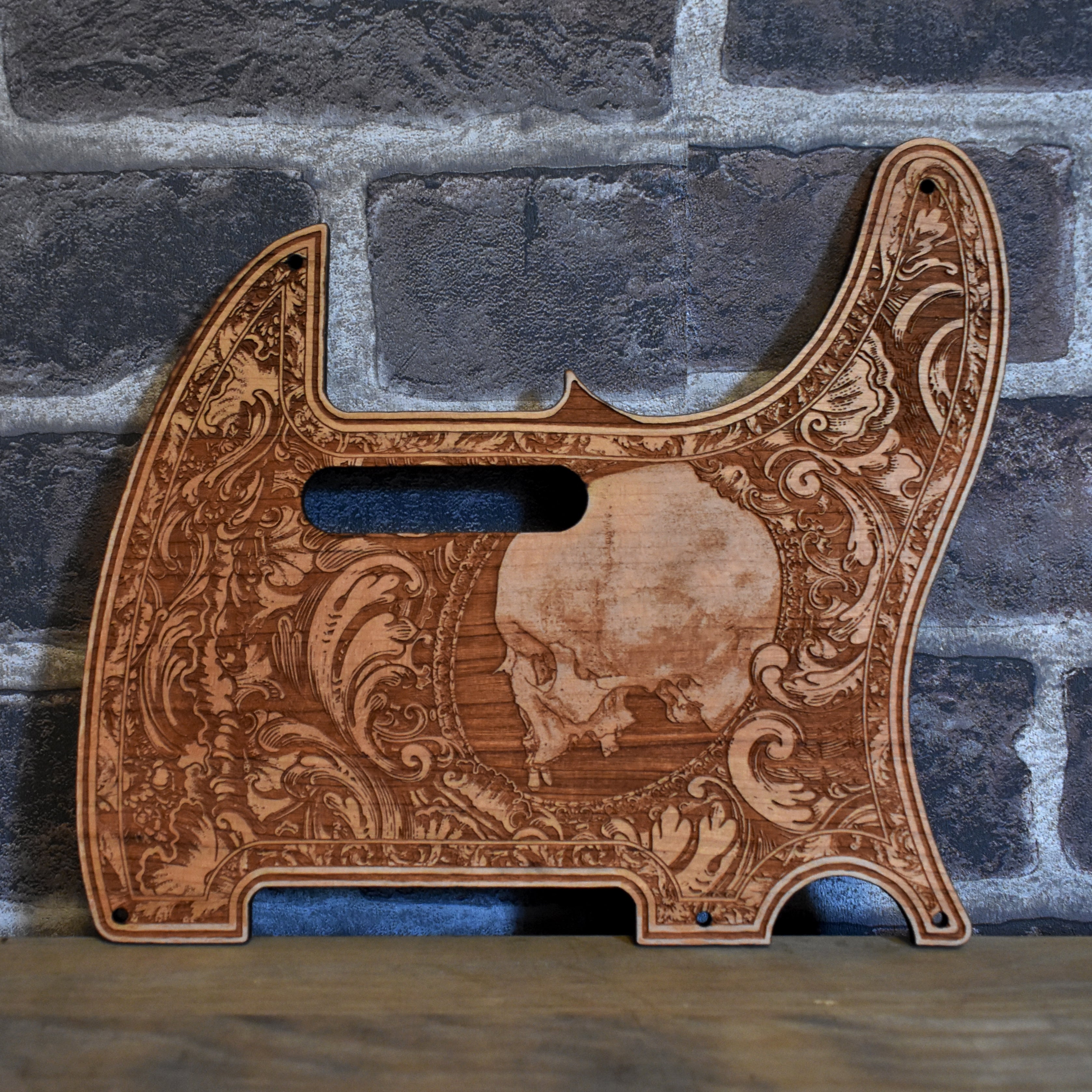 Fender Telecaster cherry wood pickguard with laser-engraved skull design – front view