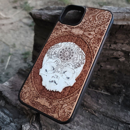 Handcrafted wood phone case featuring a gothic skull engraving, ideal for horror and skeleton art fans.