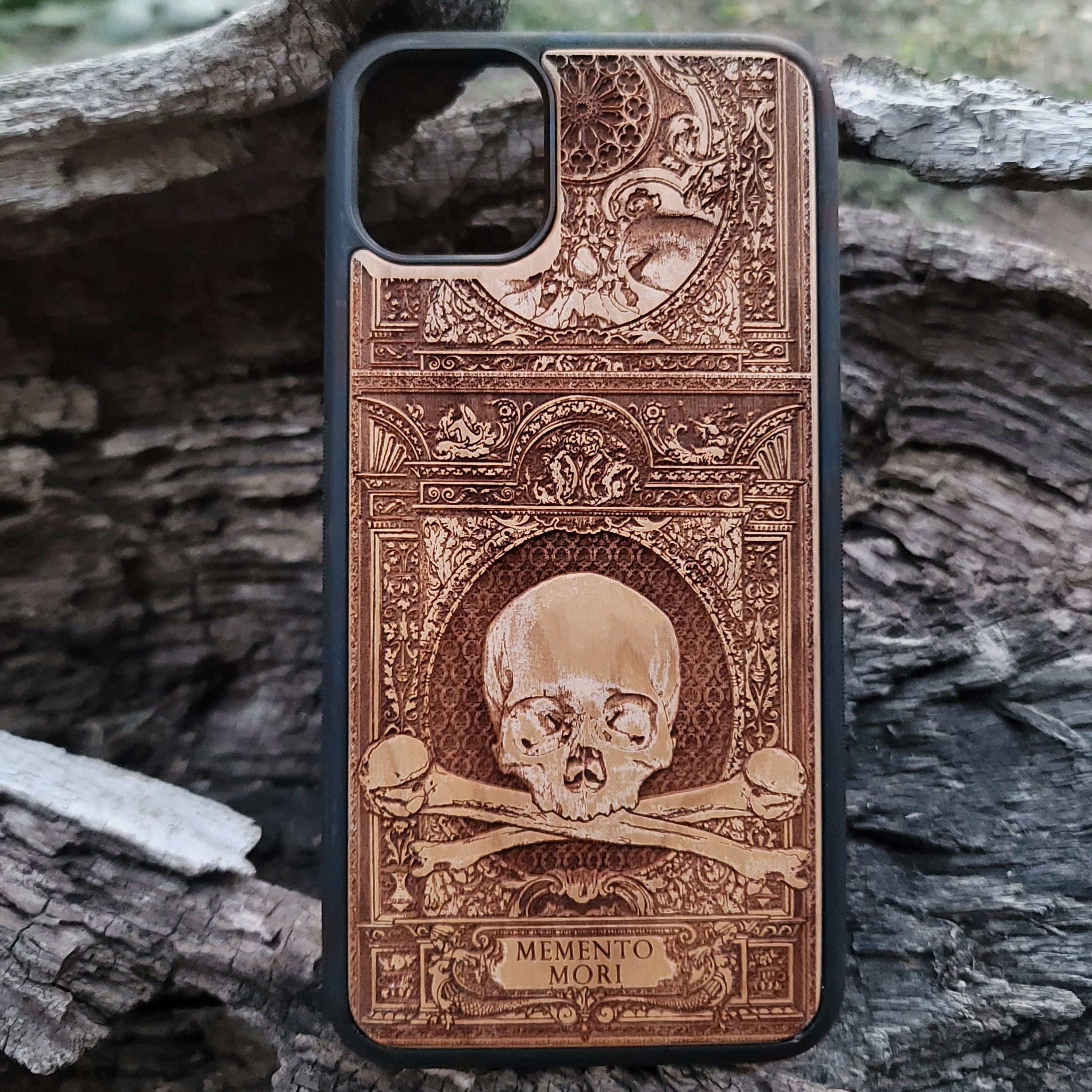 Wooden Memento Mori II phone case with intricate gothic skull design, compatible with iPhone 16, iPhone 15, Galaxy S25, Galaxy S24, and other models. Ideal for horror and gothic art lovers.