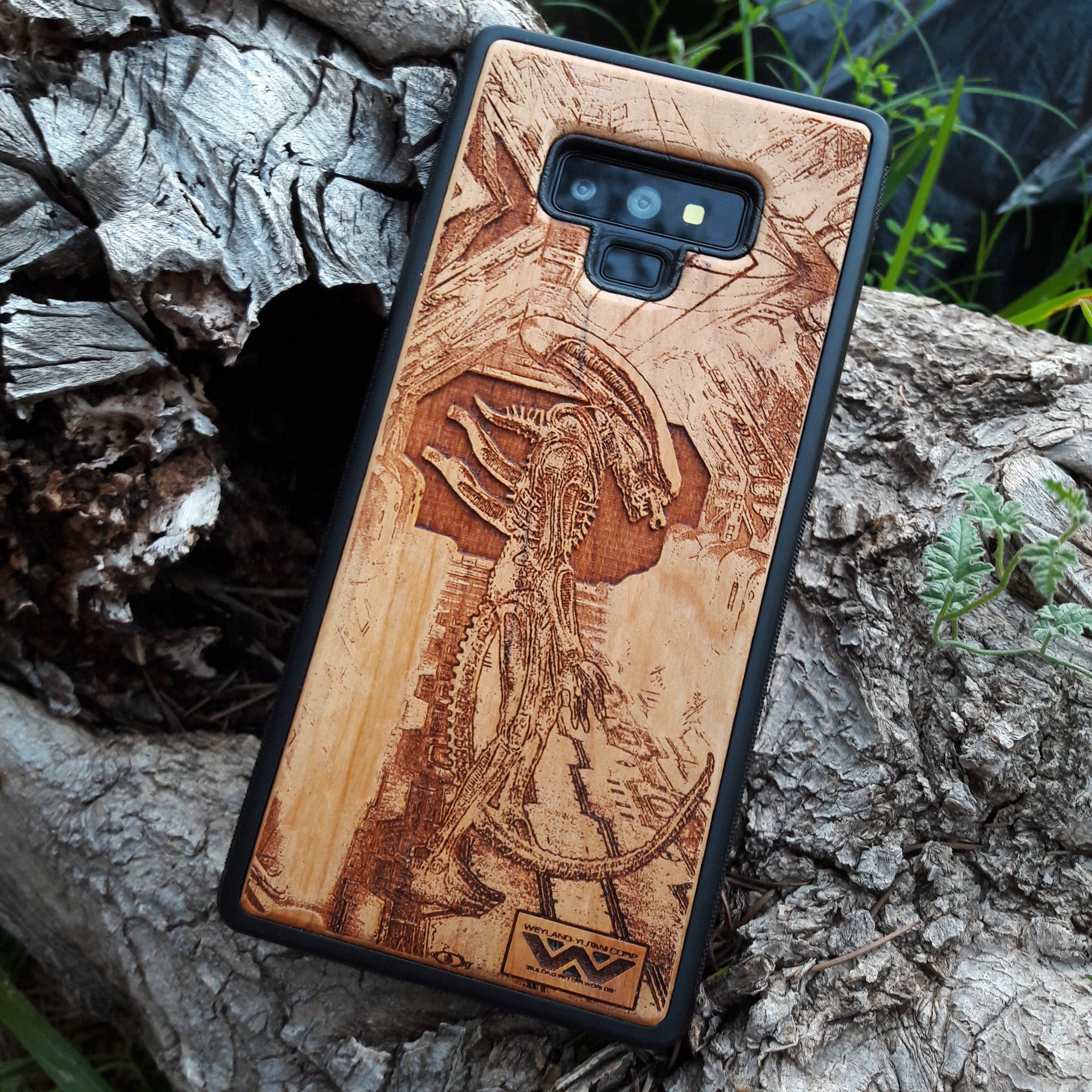 Wooden Xenomorph phone case with intricate HR Giger-inspired design, compatible with iPhone 16, iPhone 15, Galaxy S25, and more. Perfect for Alien movie fans and sci-fi lovers.